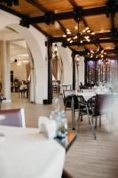 a dining room with tables and chairs in a building at PENSIUNEA ANA in Piatra Neamţ