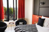 a bedroom with a bed and a chair and a window at Terrass&quot; Hotel in Paris