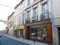 a street with a store on the side of a building at Au Nid de la Madeleine in Gaillac