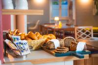 a table with bread and a basket of bread at Hotel Bergbauer in Neuburg an der Donau