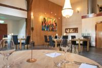 a dining room with a table with wine glasses on it at Houseboats Pean-buiten Weidum in Weidum