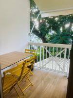 a balcony with a table and chairs and a tree at Studio Fresh&amp;Cosy Trois-Ilets - 3 étoiles-Hotel Carayou in Les Trois-Îlets