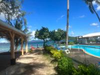 a resort with a swimming pool next to the water at Studio Fresh&amp;Cosy Trois-Ilets - 3 étoiles-Hotel Carayou in Les Trois-Îlets