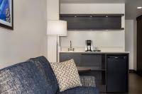 a living room with a couch and a kitchen at Holiday Inn Toronto Downtown Centre by IHG in Toronto
