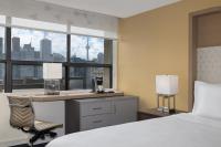 a hotel room with a desk and a bed and a window at Holiday Inn Toronto Downtown Centre by IHG in Toronto