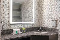 a bathroom with a sink and a mirror at Holiday Inn Toronto Downtown Centre by IHG in Toronto