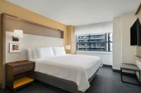 a hotel room with a large bed and a window at Holiday Inn Toronto Downtown Centre by IHG in Toronto