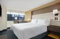a hotel room with a large white bed and a window at Holiday Inn Toronto Downtown Centre by IHG in Toronto