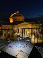 a table with wine glasses on top of a building at Palazzo Sovrana Serviced Luxury Apartments in Palermo