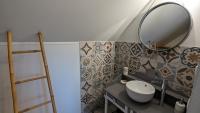 a bathroom with a sink and a mirror on the wall at Au Bonheur de Cisse in Chouzy-sur-Cisse