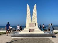 people walking around a monument in front of the beach at Apartment L&#39;Oustalet-3 by Interhome in Mimizan-Plage