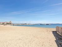 a view of the beach with a pier in the background at Apartment Le Grand Large-1 by Interhome in Sainte-Maxime
