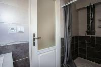 a bathroom with a shower and a white door at Appartement d&#39;une chambre avec vue sur la ville et wifi a Embrun in Embrun