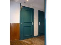 two green doors in a room with wooden floors at Appartement d&#39;une chambre avec vue sur la ville et wifi a Embrun in Embrun