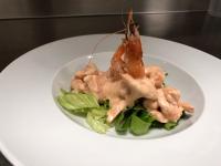 a white plate of food with shrimp on a salad at Bella Napoli albergo Chiari in Chiari