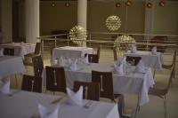 a room with white tables and chairs with white napkins at BLUEBAY HOTEL ABIDJAN in Abidjan