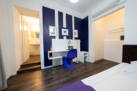 a bedroom with a desk and a blue chair at Hotel Bergbauer in Neuburg an der Donau