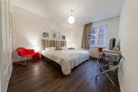 a bedroom with a bed and a red chair at Hotel Bergbauer in Neuburg an der Donau