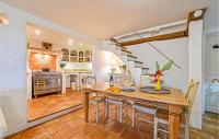 a kitchen and dining room with a wooden table at Awesome Home In Fontarches With 2 Bedrooms, Wifi And Outdoor Swimming Pool in Fontarèches