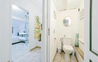 a white bathroom with a toilet and a sink at Awesome Home In Fontarches With 2 Bedrooms, Wifi And Outdoor Swimming Pool in Fontarèches