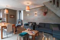 a living room with a couch and a table at Chalet Bio Corti 6p. 3 ch proche pistes&#47;commerces in Champagny-en-Vanoise