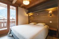 a bedroom with a large bed and a large window at Chalet Bio Corti 6p. 3 ch proche pistes&#47;commerces in Champagny-en-Vanoise