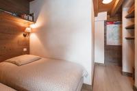 a bedroom with a bed and a wooden wall at Chalet Bio Corti 6p. 3 ch proche pistes&#47;commerces in Champagny-en-Vanoise