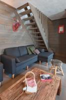 a living room with a blue couch and a stairs at Chalet Bio Corti 6p. 3 ch proche pistes&#47;commerces in Champagny-en-Vanoise