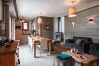 a kitchen and living room with a table and a couch at Chalet Bio Corti 6p. 3 ch proche pistes&#47;commerces in Champagny-en-Vanoise