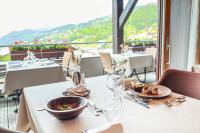 a table with plates of food on top of a restaurant at Hôtel Alpina &amp; SPA in Les Gets
