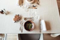 a table with a bowl of food and glasses on it at Hôtel Alpina &amp; SPA in Les Gets