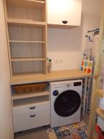 a laundry room with a washing machine and shelves at Les Terrasses du Phenix in Saint Alban Auriolles
