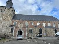 a large brick church with a clock tower at Impasse 1 in Fosses-La-Ville
