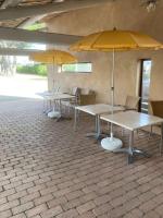 a row of tables with umbrellas in a building at Studio «  Lisbonne » à Avignon in Avignon