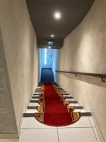 a long staircase with red carpet and chairs on it at Studio «  Lisbonne » à Avignon in Avignon