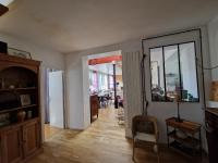 a living room with a door open to a dining room at Loft en duplex 270 m2 &amp; Jardin patio terrasse sauna in Chaville