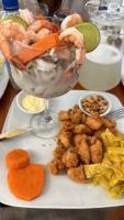 a plate of food with shrimp and vegetables on a table at Las Fragatas Casa Hotel in Canoas De Punta Sal