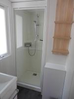 a bathroom with a shower with a glass door at Mobile home 5-pers Camping Leï Suves-Côtes d&#39;Azur-including airco in Roquebrune-sur-Argens