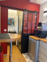 a kitchen with red walls and a wooden counter top at Paris-Zénith-bienvenue-terrasse-Netflix in Pantin