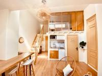 a kitchen with a staircase and a living room at Cosy Cœur de Lille in Lille