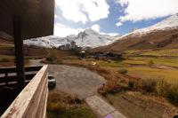 a view of the mountains from a balcony of a house at Duplex 65 m2 au coeur du golf de Tignes in Tignes