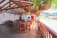 Un comedor con mesas y sillas de madera. en Hotel las Palmas, en Villa de Leyva