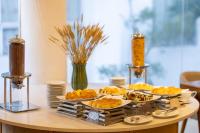 a table with three plates of food on it at Rosaleen Boutique Hotel in Hue