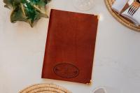 a brown book sitting on top of a table at Oryx Boutique Hotel in Klerksdorp