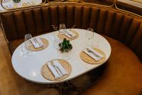 a white table with plates and wine glasses on it at Oryx Boutique Hotel in Klerksdorp