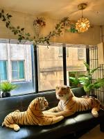 two tigers sitting on a couch in a room at Taipei Triple Tiger Inn in Taipei