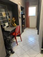 a room with a desk and a red chair at LA MARIEFACTURE - Comme c&#39;est chic in Saint-Avold