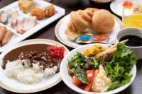 a table topped with plates of food with rice and vegetables at APA Hotel TKP Nippori Ekimae in Tokyo