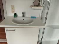 a sink in a bathroom with a white counter at Logies Lily in Oudenburg