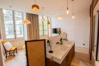 a bathroom with a sink and a desk in a room at LOLA Boutique Hôtel - Bordeaux Centre in Bordeaux